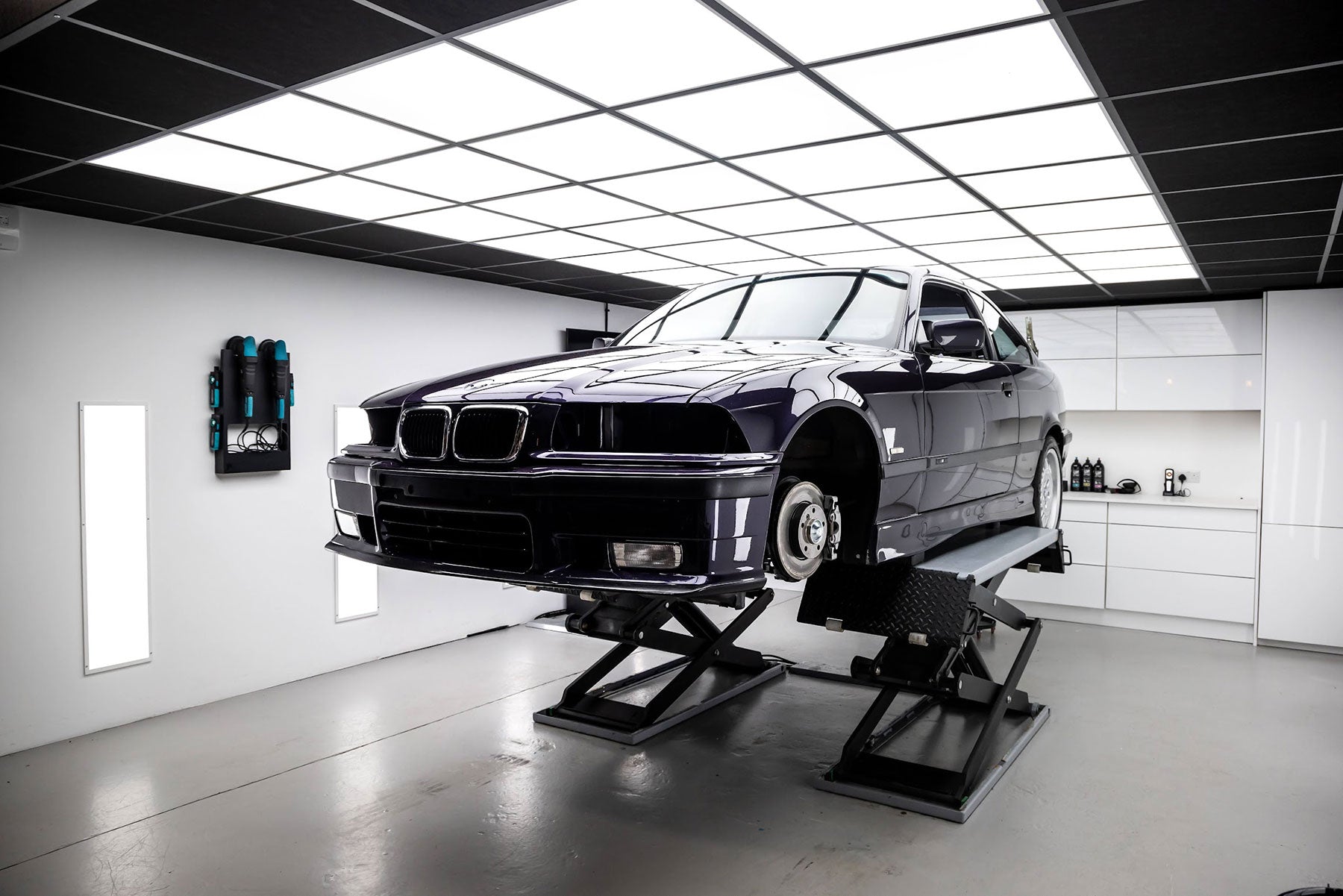 BMW car on a lift in a garage setting