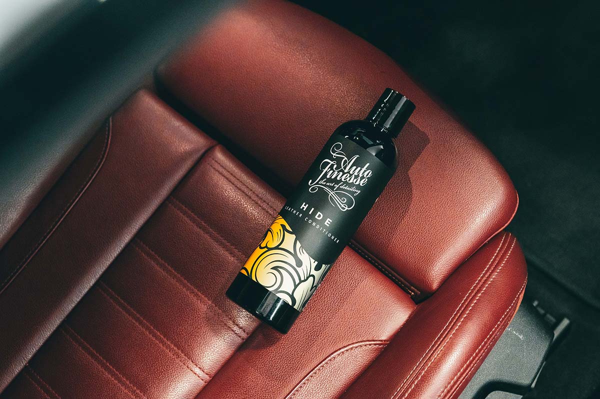 Bottle of 'Auto Finish' product on a car seat