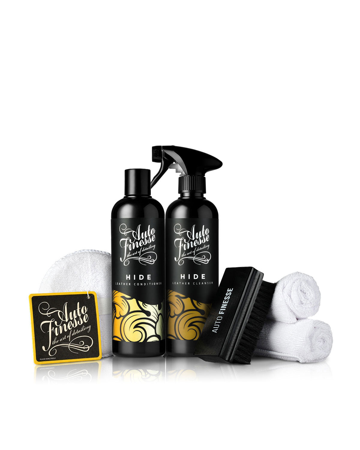 Automotive care product set with bottles, brush, and cloths on a white background