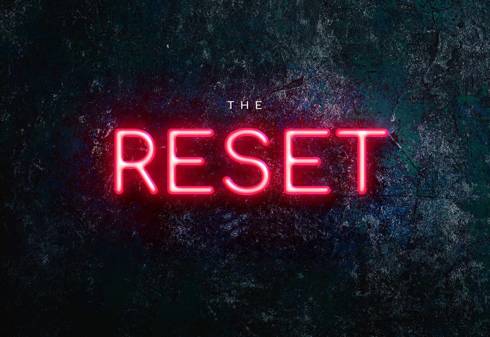 Neon sign with 'The Reset' text on a dark textured background